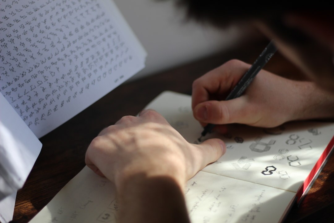 person sketching on paper