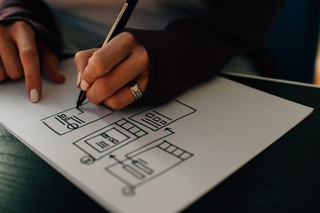 person sketching in notebook